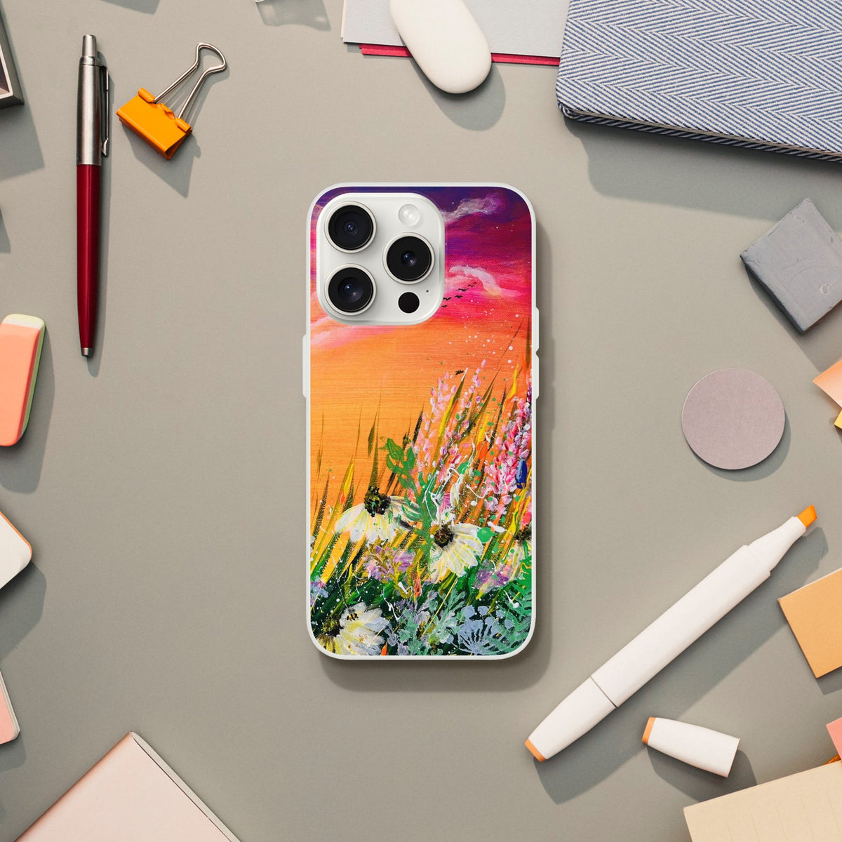 Flexible phone case featuring a vibrant, artistic nature print of wildflowers against a colorful sunset sky.