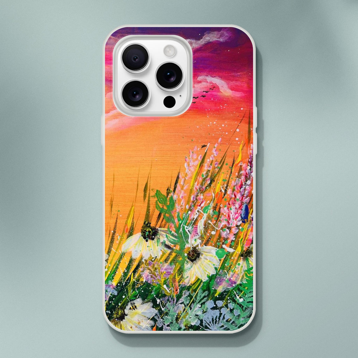 Flexible phone case featuring a vibrant nature painting of wildflowers against a colorful orange and purple sunset sky.