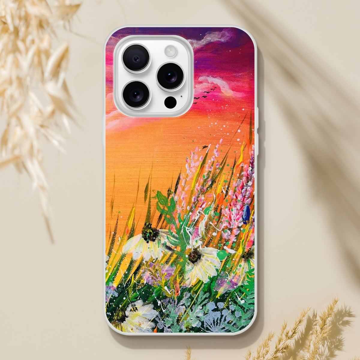 Flexible phone case featuring a vibrant, artistic nature painting of wildflowers against a sunset sky.