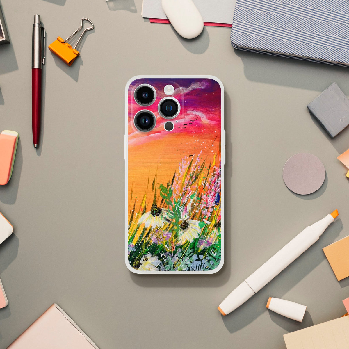 Flexible phone case featuring a vibrant sunset landscape with wildflowers and a frosty transparent border.