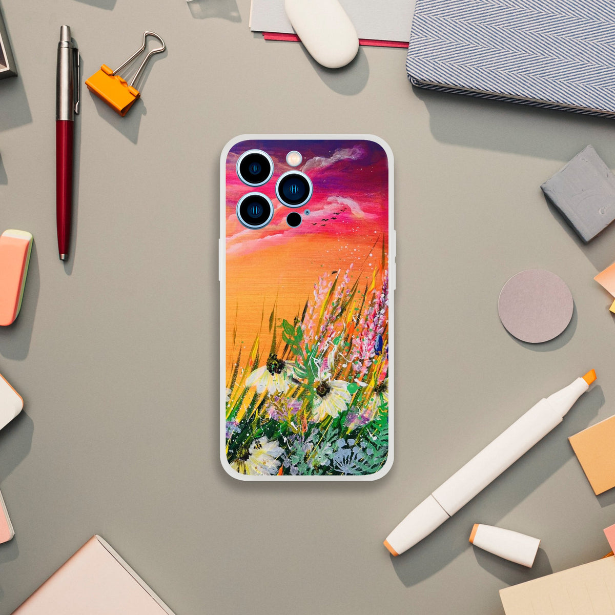 Flexible phone case featuring a vibrant sunset meadow painting with wildflowers on a frosty transparent background.