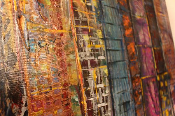 Abstract textured paint surface with layered hex and brick-like patterns in blue and orange.