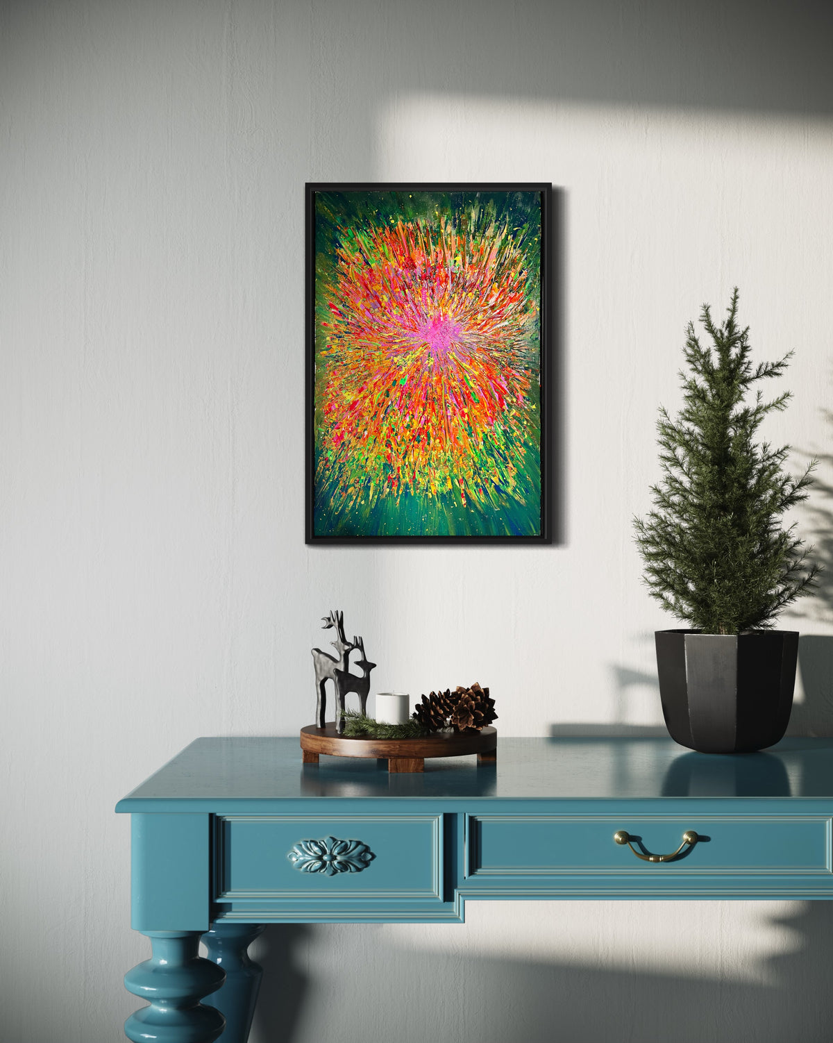 Framed abstract burst artwork with neon multicolor rays on a green field, black frame.