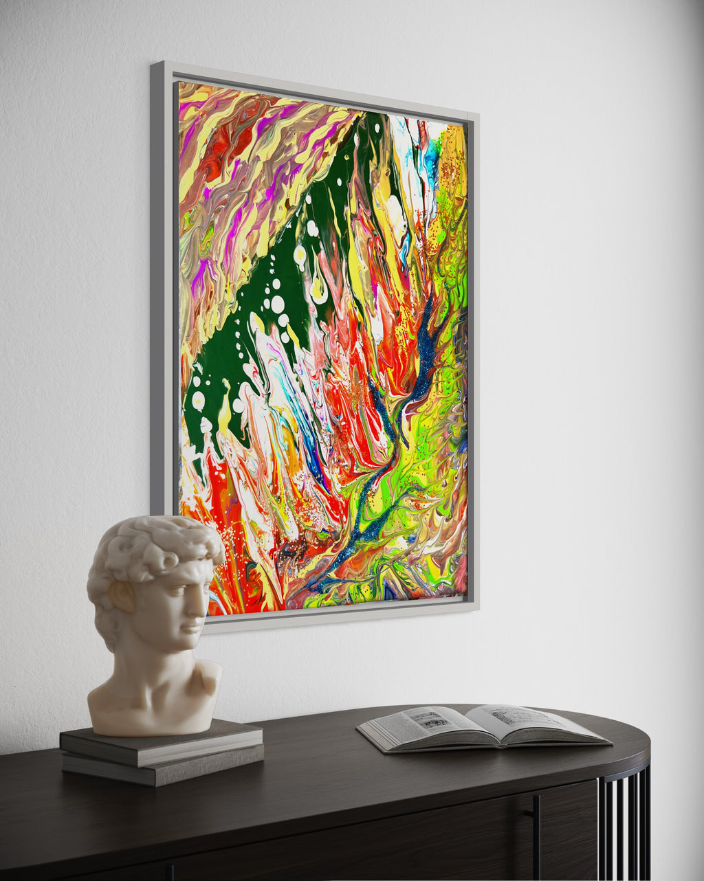 Framed abstract wall art print with vibrant green, orange, and red paint, plus white speckles