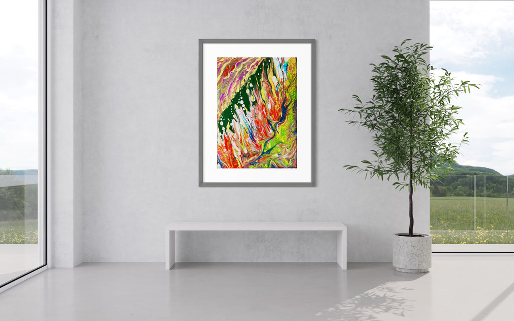Framed abstract wall art print with vibrant paint streaks and splatters on a clean white wall