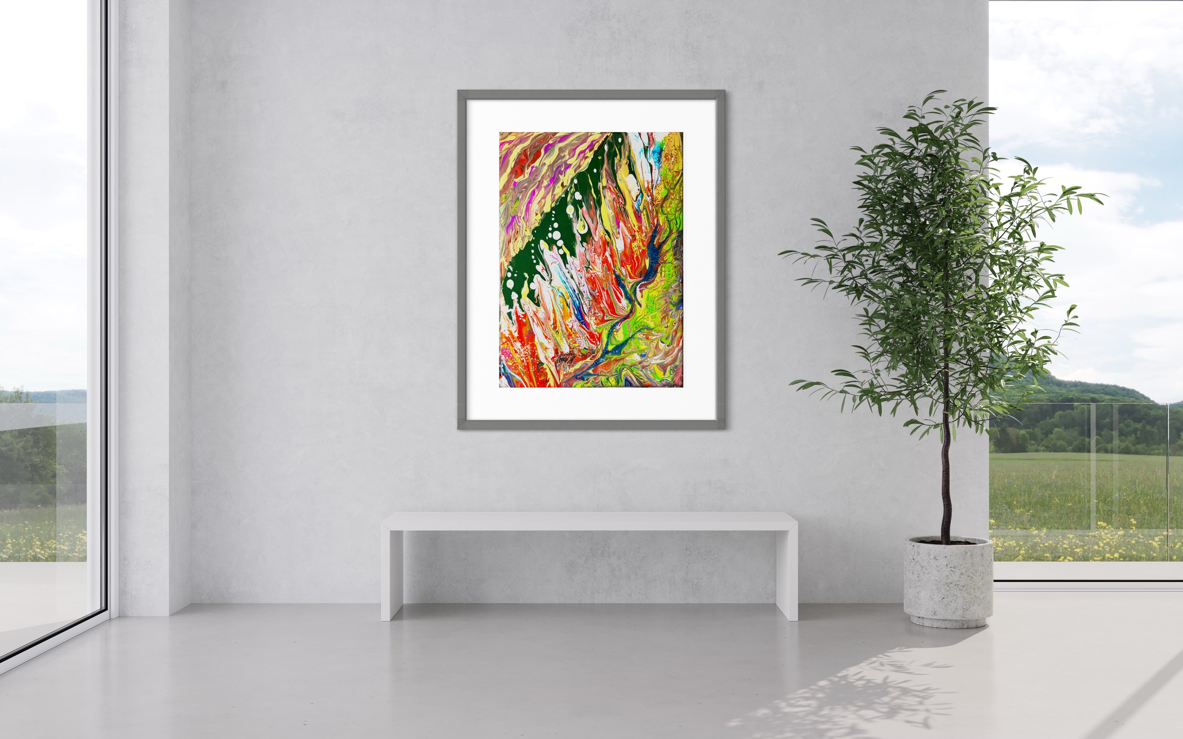 Framed abstract wall art print with vibrant paint streaks and splatters on a clean white wall