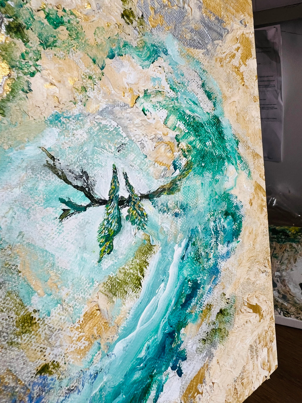Abstract canvas wall art with turquoise river and green birds, shown on display