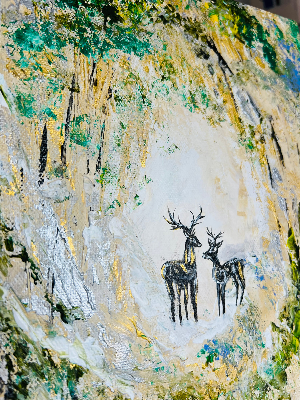 Canvas wall art close-up with two deer silhouettes beneath layered paint texture