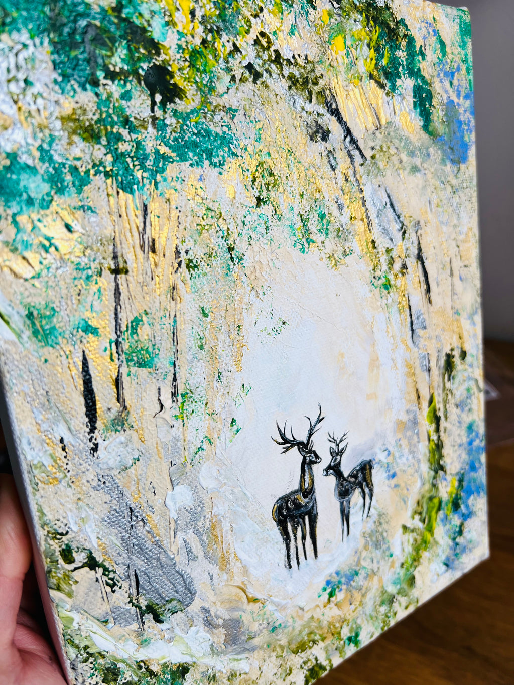 Canvas wall art with two deer silhouettes on a textured landscape background