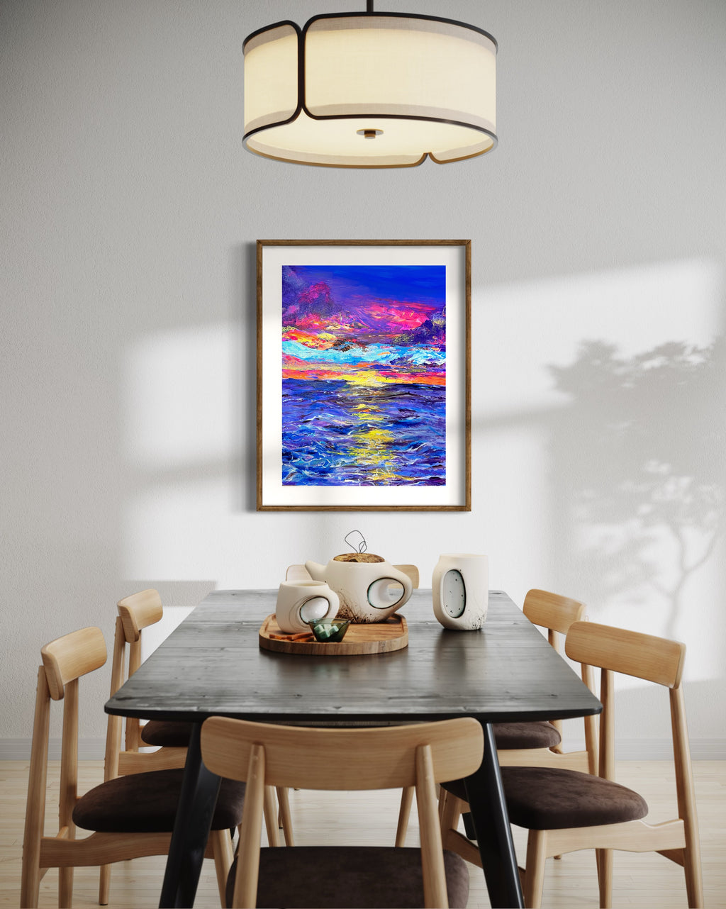 Framed abstract landscape wall art with gold frame and bright blue, pink, and yellow hues