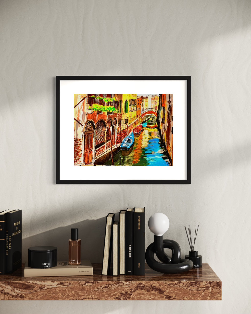 Black-framed Venice canal artwork with a gondola beside bright turquoise water