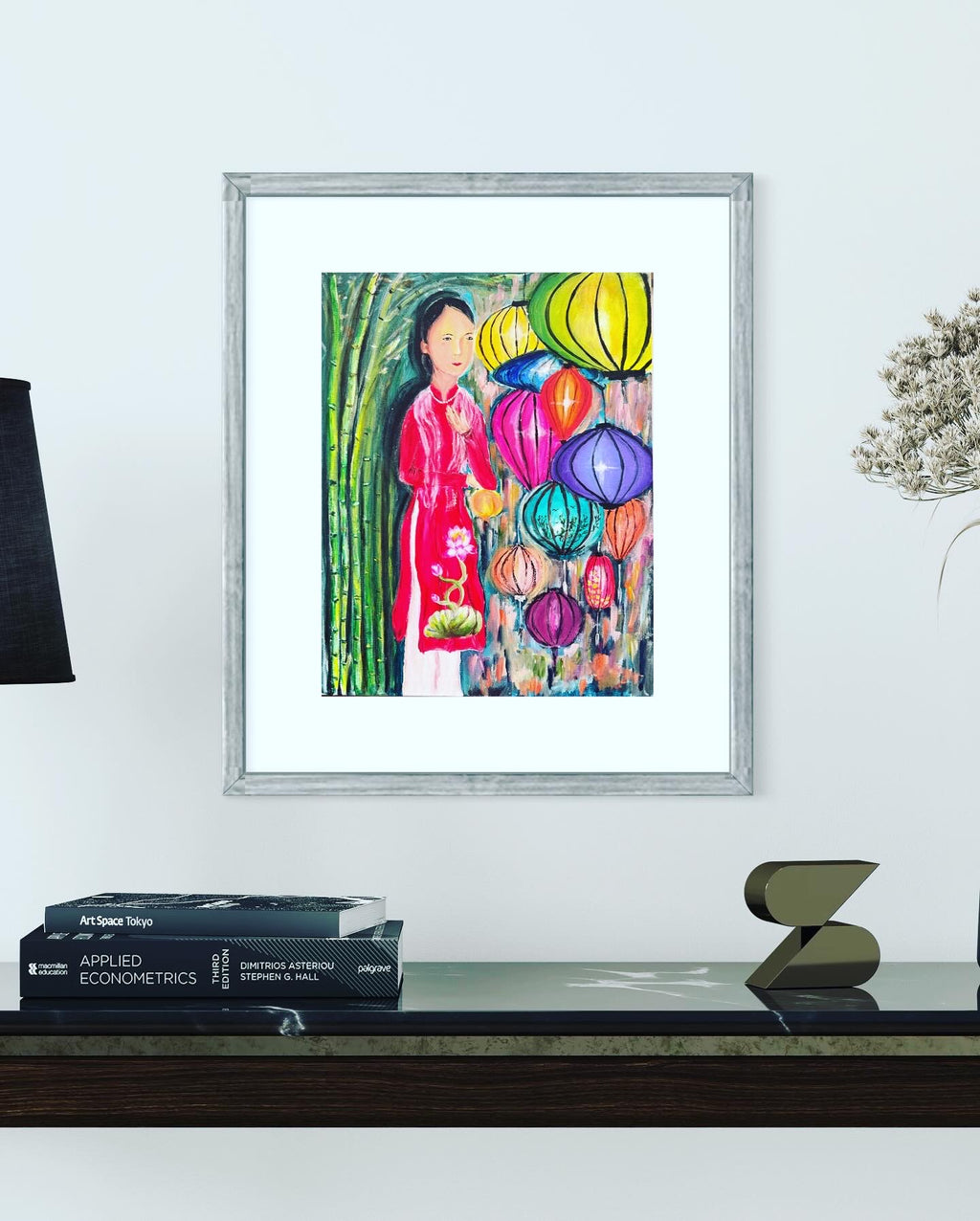 Framed acrylic on canvas painting of a Vietnamese woman in red with hanging colorful lanterns