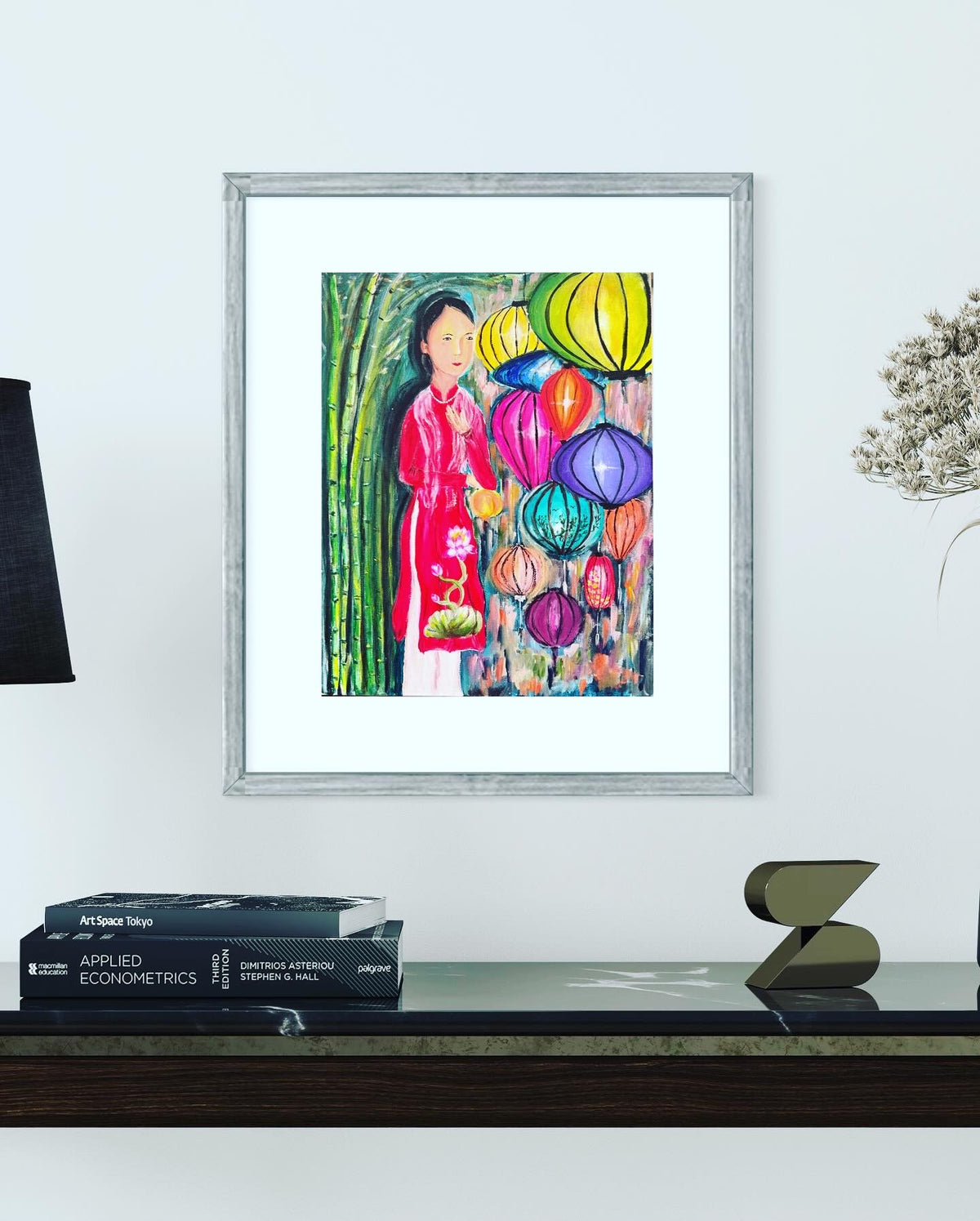 Framed acrylic on canvas painting of a Vietnamese woman in red with hanging colorful lanterns