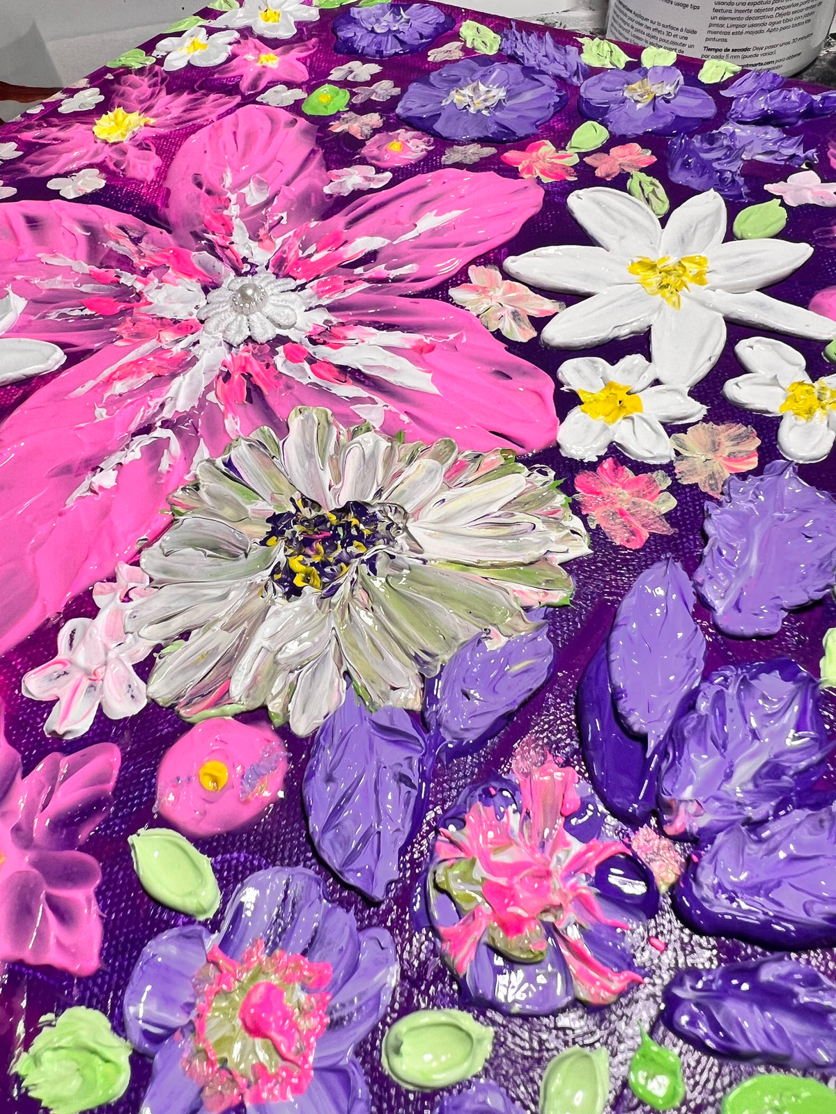 Thick texture floral art close-up with white daisies and sparkling pink, blue, and green blossoms