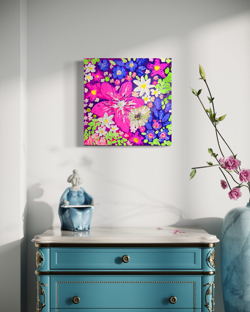 Framed thick texture floral wall art above a blue cabinet, featuring white daisies and bright petals