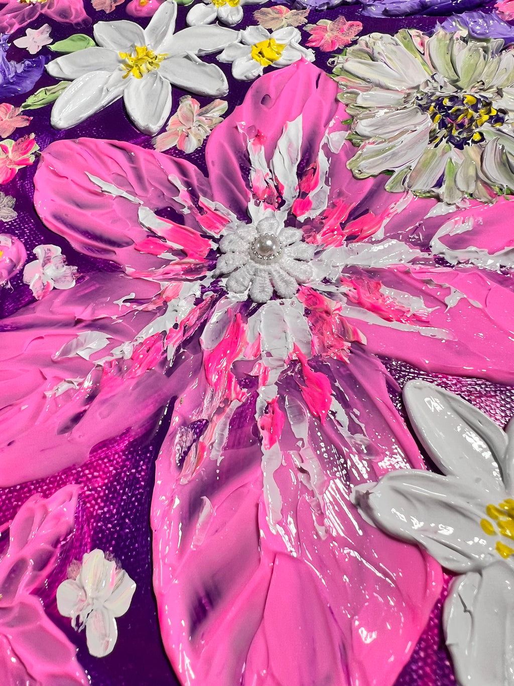 Thick texture floral art close-up with white daisies over glossy pink petals and blue background